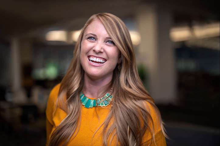 A laughing SCE employee in a darkened office