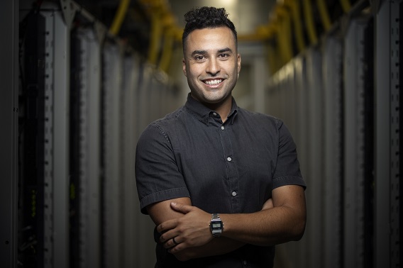 A man with his arms crosses looking at the camera