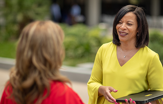 Two professional women talking to each other