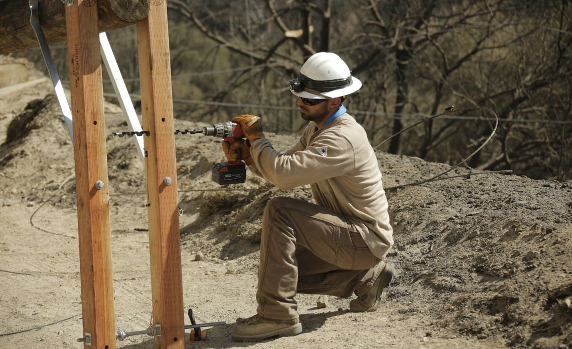 A man drilling into wood column