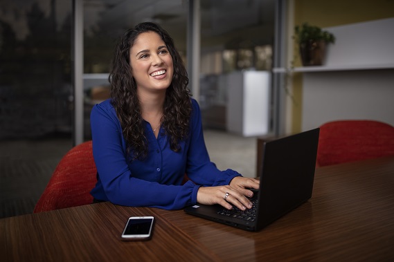 woman typing and smiling