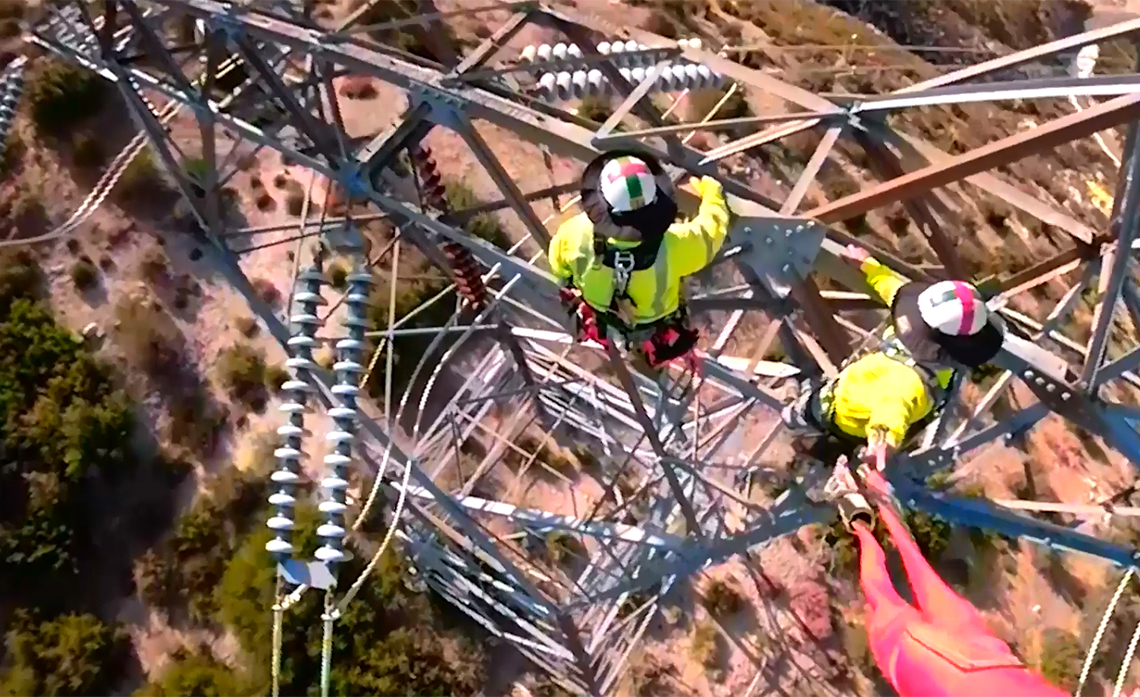 Aerial image of linemen on working on electrical towers