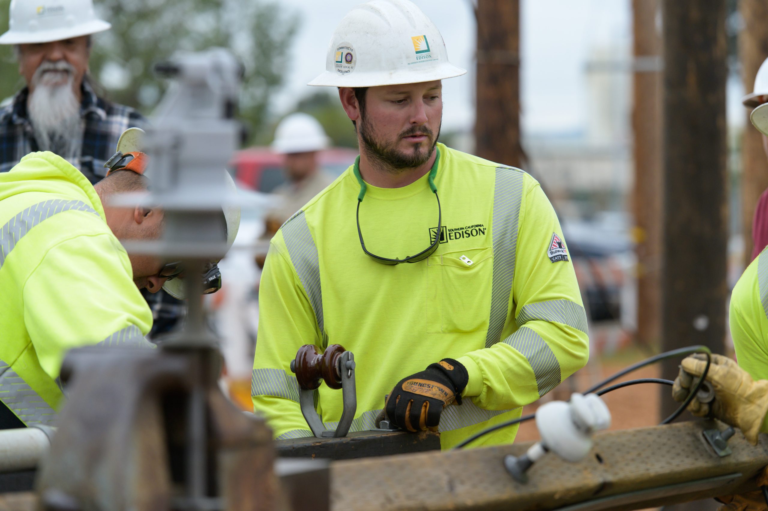 Men in hardhats and Edison gear working on a job site