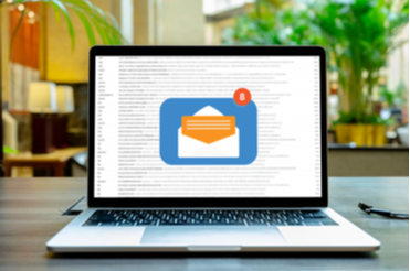 A laptop open with an email icon